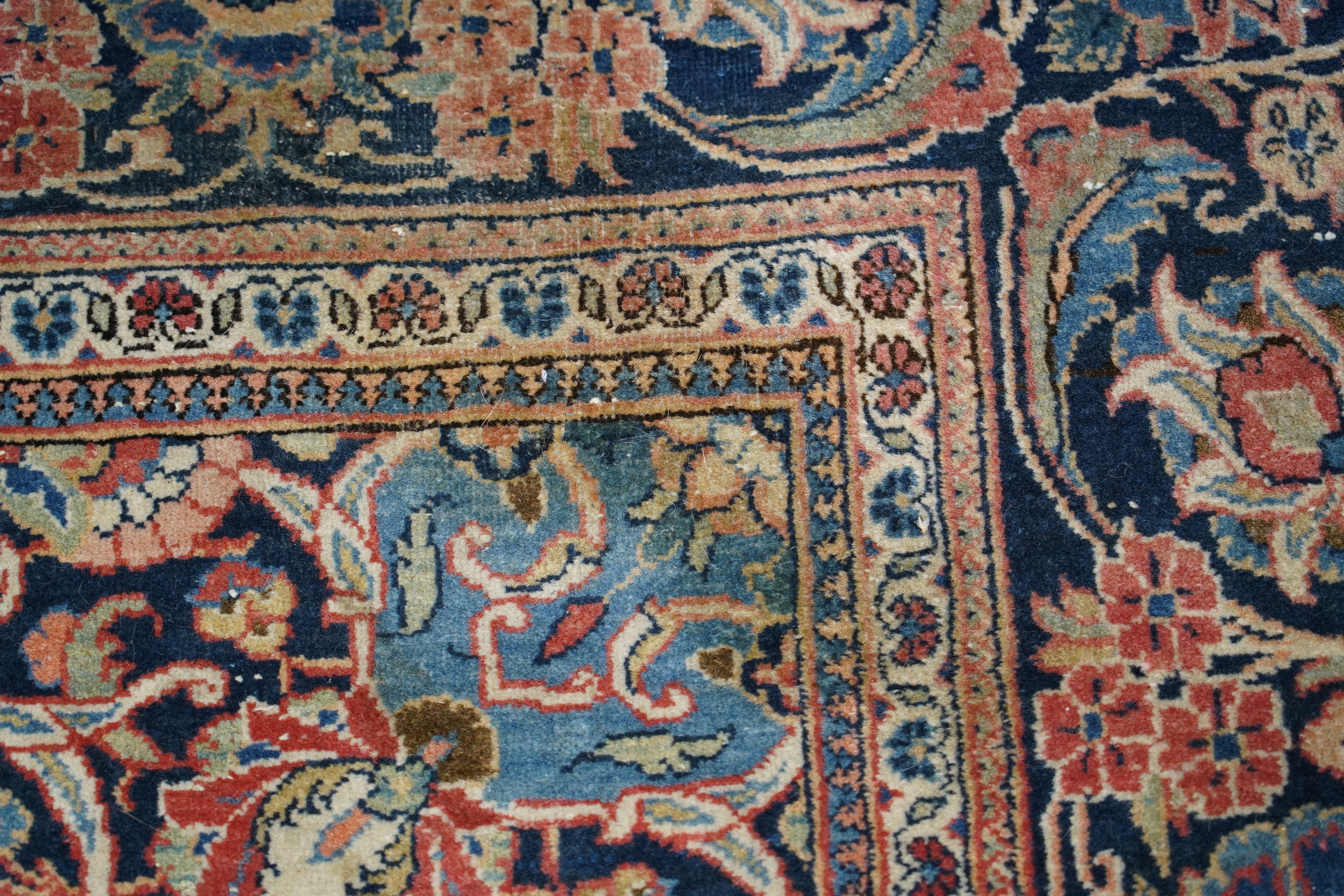 A pair of antique Tabriz brick red ground rugs, 200 x 136cm. Condition - fair